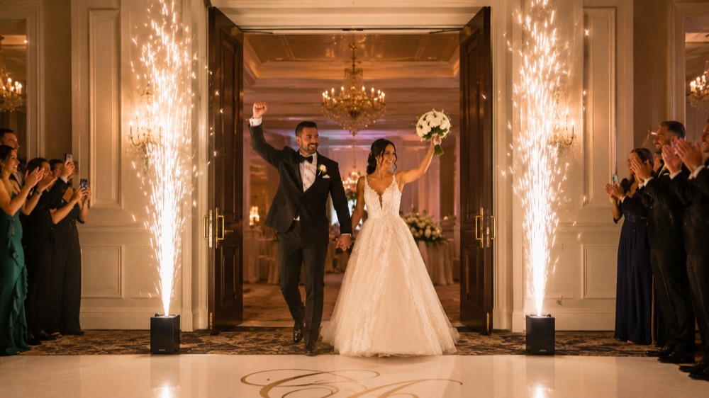 Cold spark fountains framing a couple's grand entrance