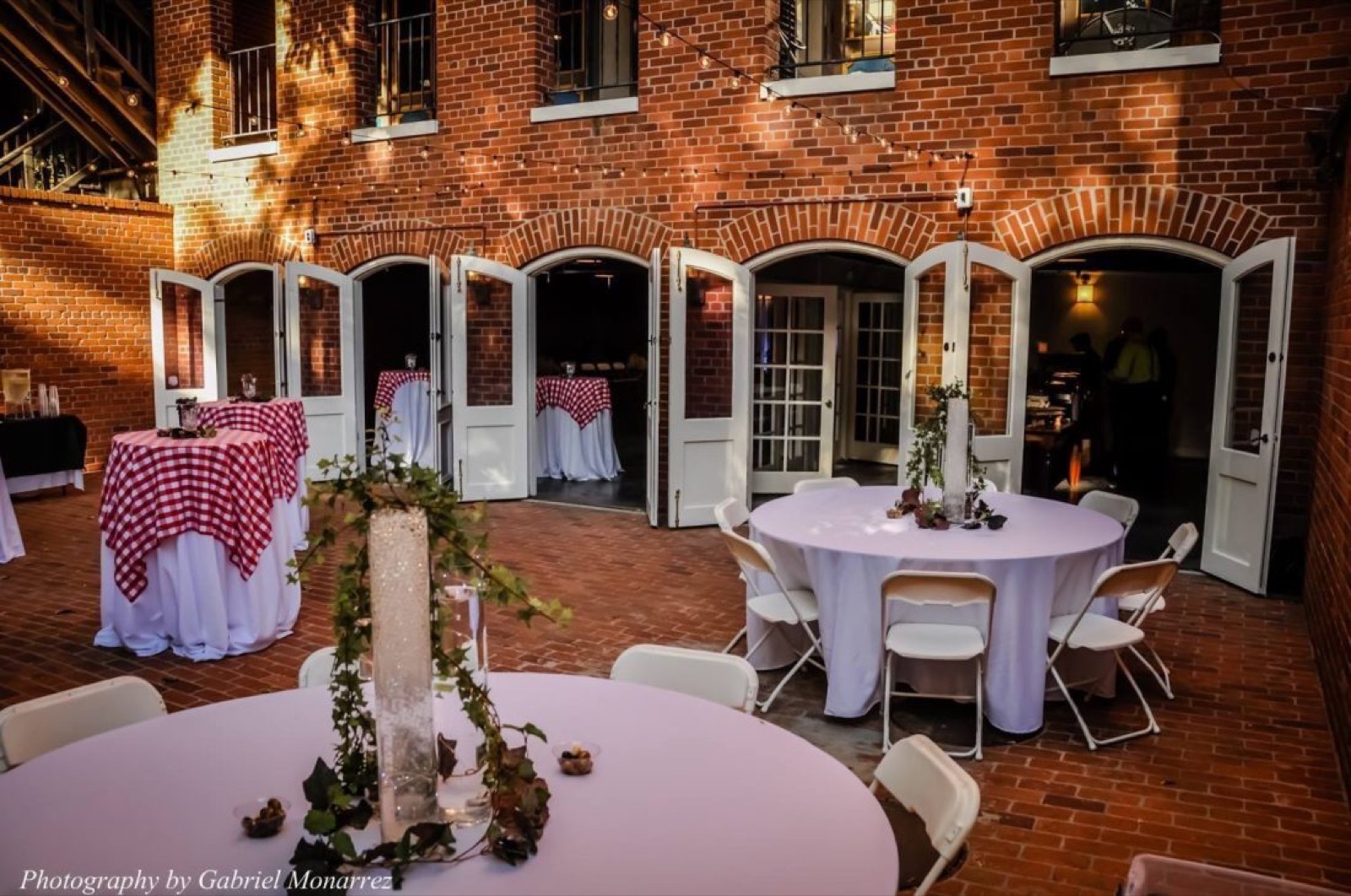 Reception space with industrial girder ceiling at Arcade Underground wedding venue in Sacramento, CA