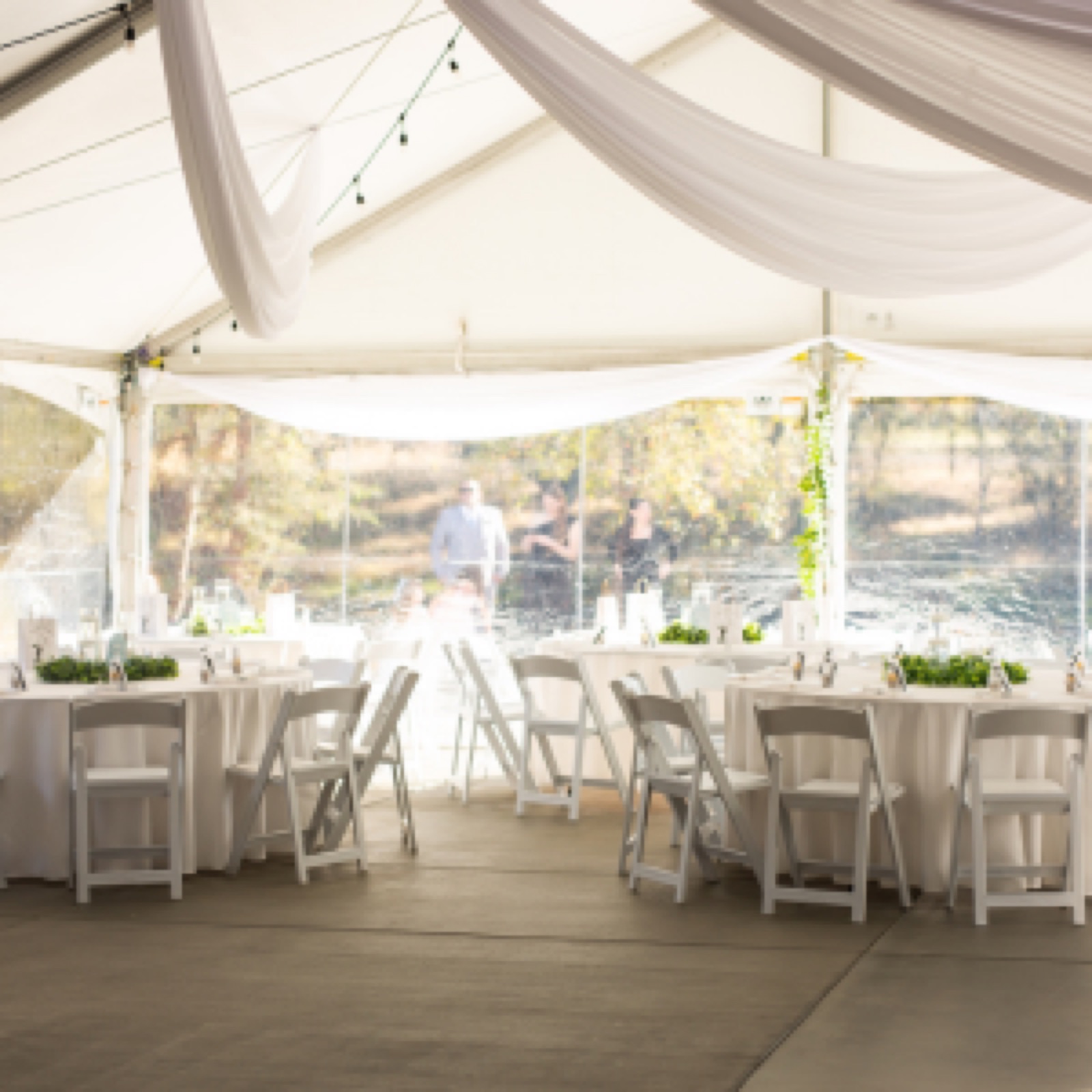 Tented wedding reception with tables set up at Belledor Vineyards in Plymouth, California