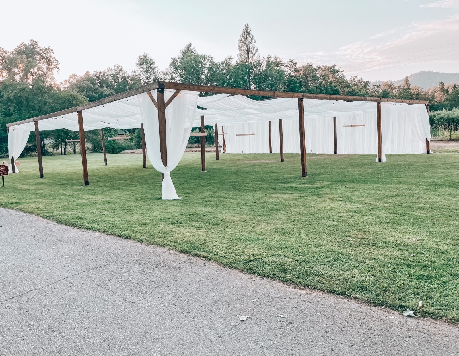 Rustic wood structure rental setup by Burner Custom Designs and Events in Hilmar, California