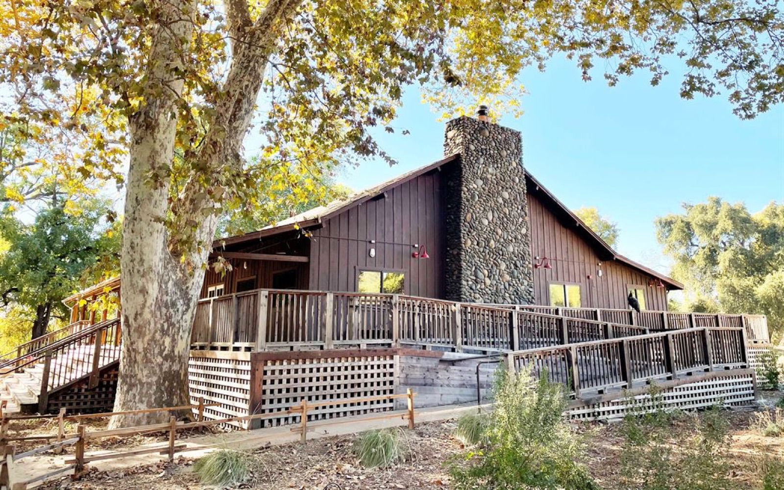 Open lawn framed by mature trees at Camp Pollock wedding venue in Sacramento, California