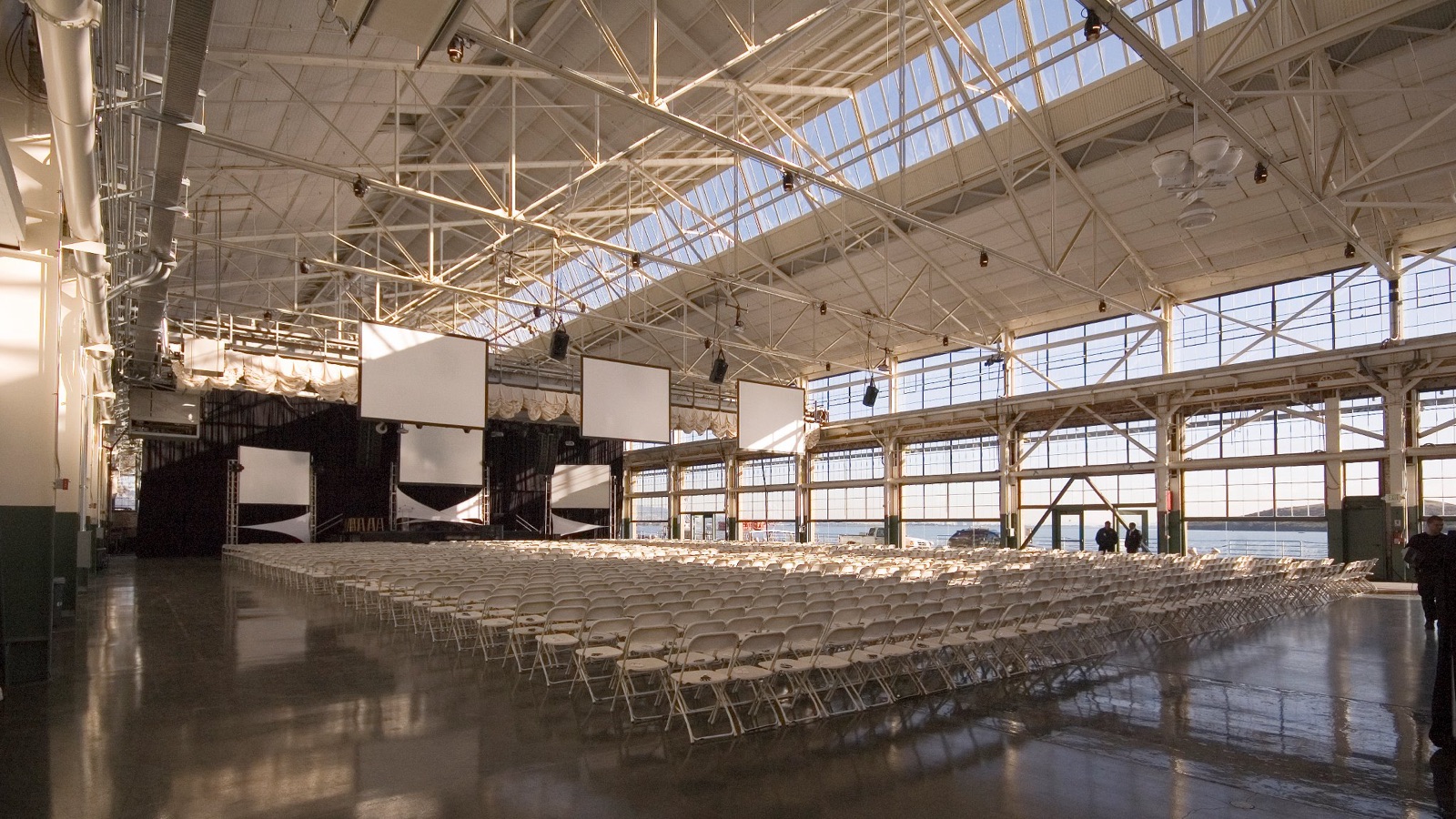 Light-filled ceremony space framed by floor-to-ceiling glass at Craneway Pavilion, Richmond, California