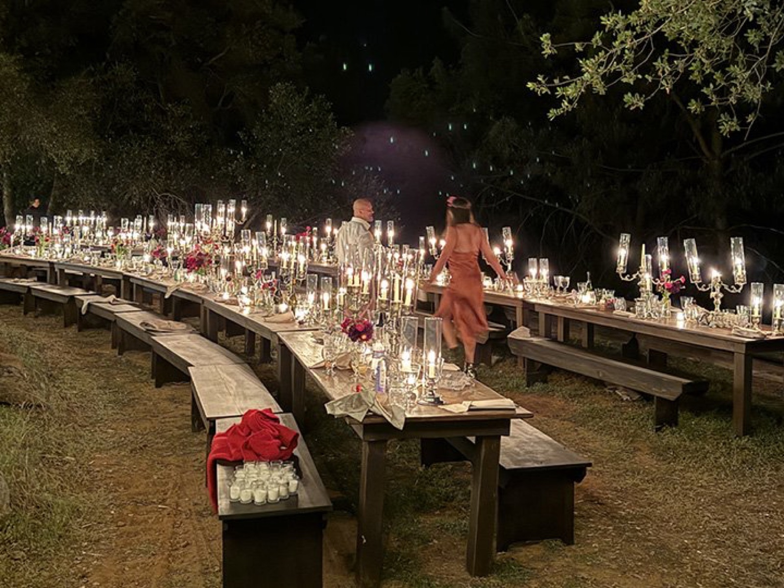 Candlelit reception dinner among the trees at Deloro Valley wedding venue in Tuolumne, California