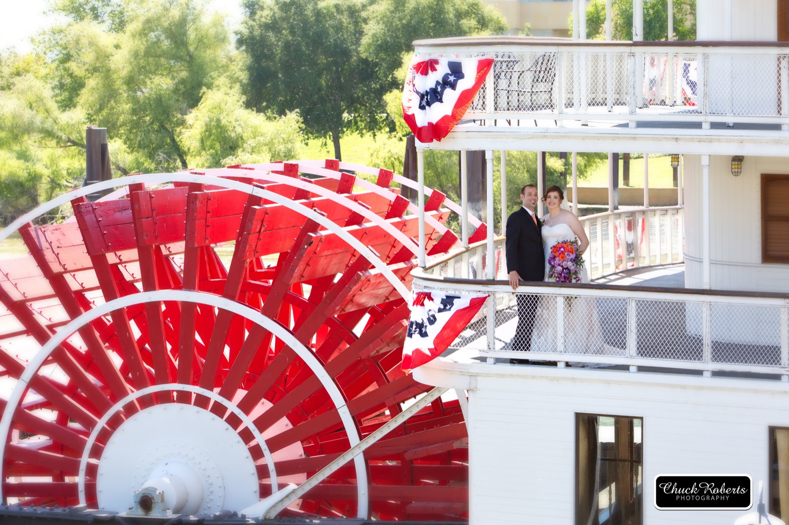 Couple celebrating their wedding on the riverfront deck of the Delta King Hotel in Sacramento, California
