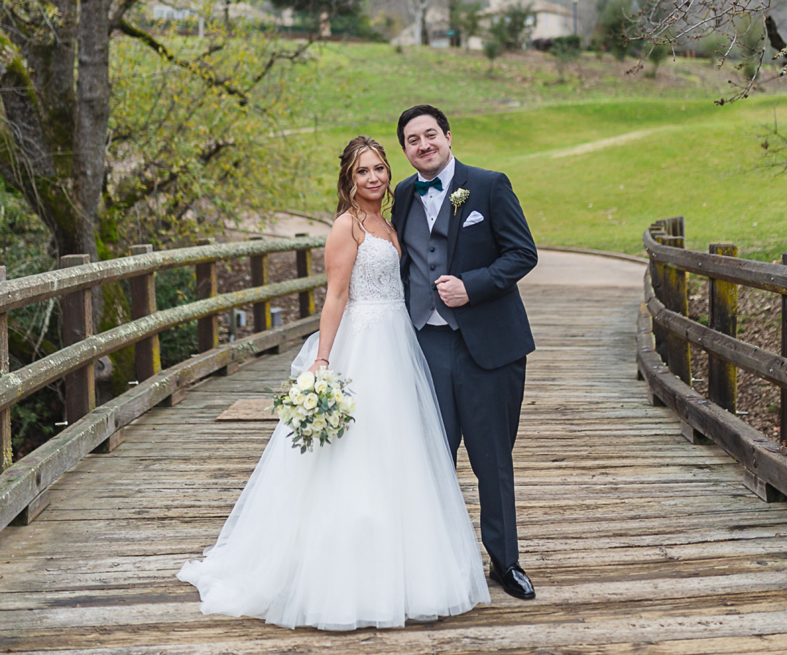 Couple on a bridge amid the grounds at Eagle Ridge by Wedgewood Weddings in Gilroy, California