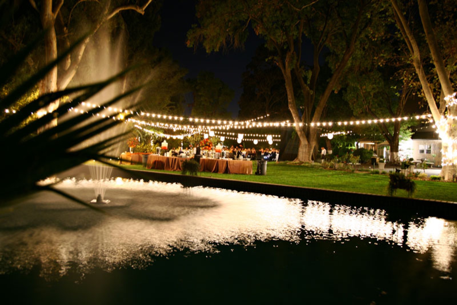 Poolside fountain ceremony backdrop at Evanshire Gardens wedding venue in Ceres, California