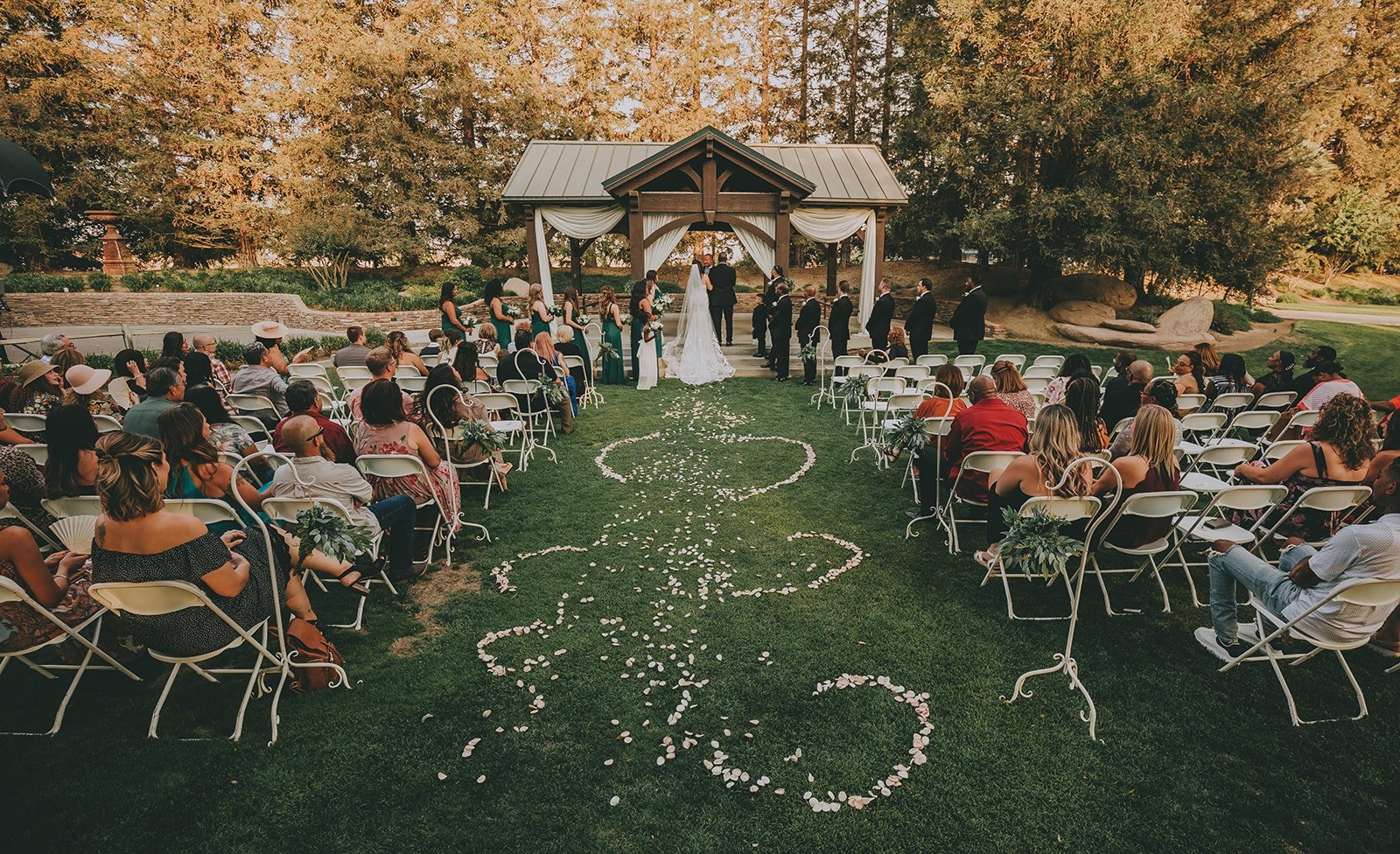Ceremony aisle with florals at Holland Park West, a Fresno, California wedding venue
