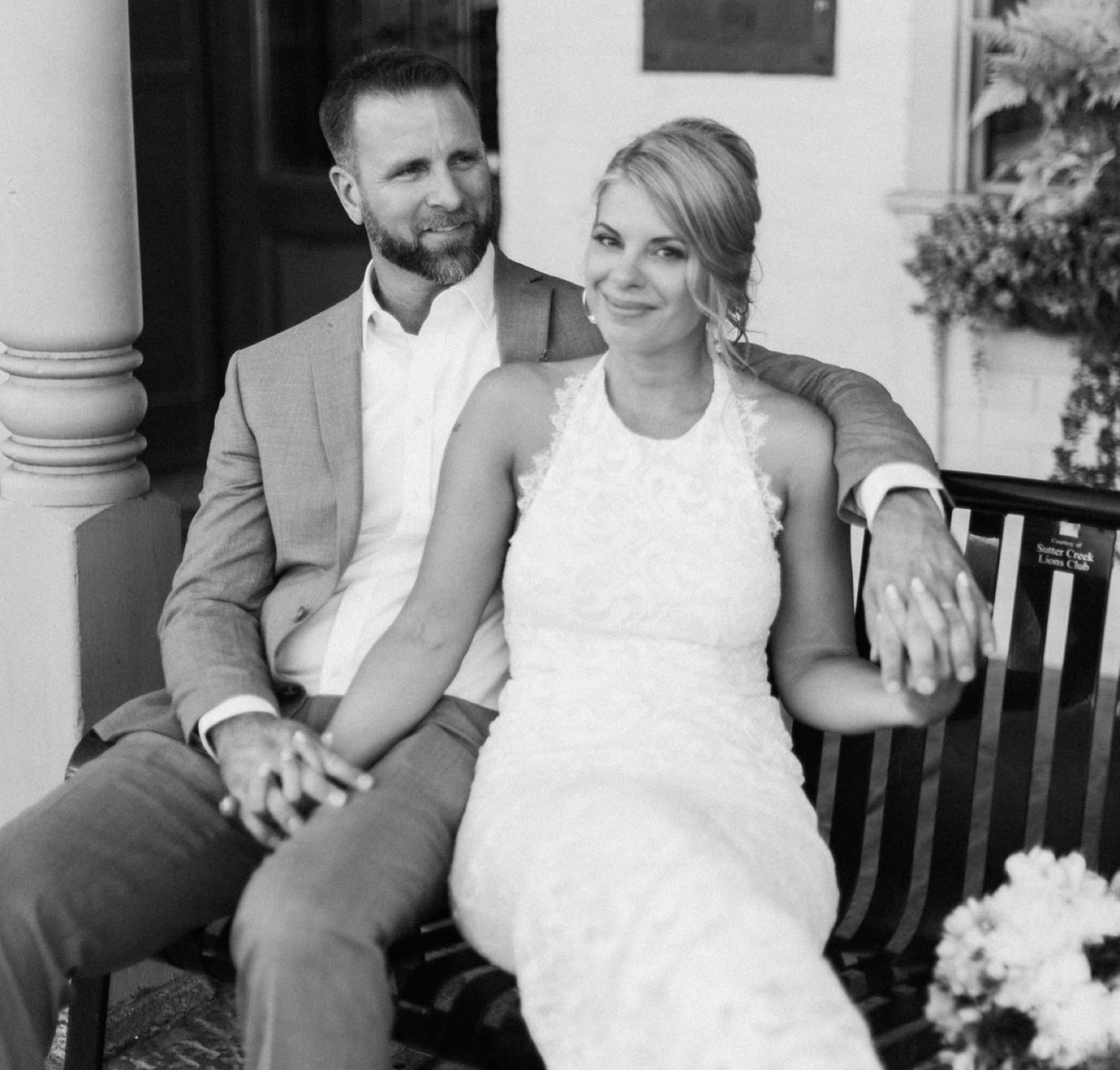 Wedding couple seated on a bench at Hotel Sutter in Sutter Creek, CA
