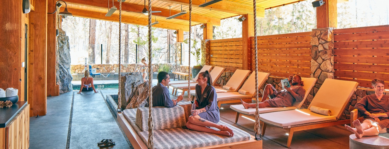 Spa outdoor lounge surrounded by pines at Rush Creek Lodge & Spa in Groveland, California