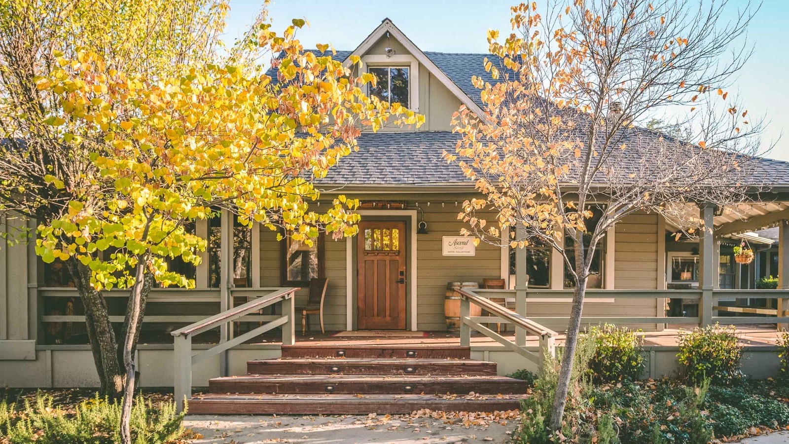 Historic 1875 ranch hotel exterior among towering oaks and pines at Sierra Sky Ranch in Oakhurst, California