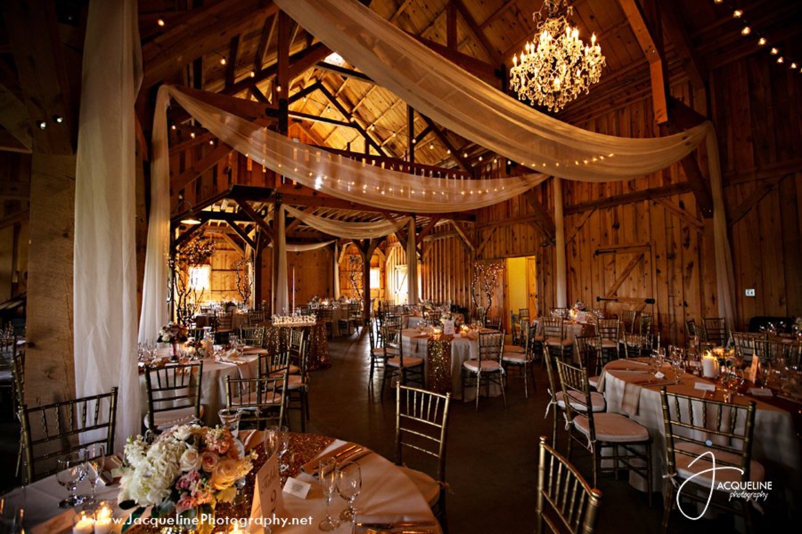 Draped barn interior set for a reception at The Barn at Amador Cellars in Plymouth, California