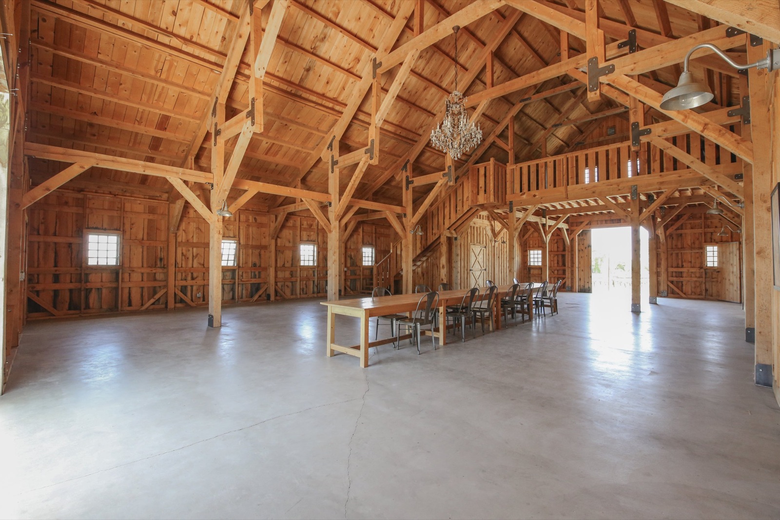 Barn interior with high ceilings and chandelier at The Barn at Amador Cellars in Plymouth, California
