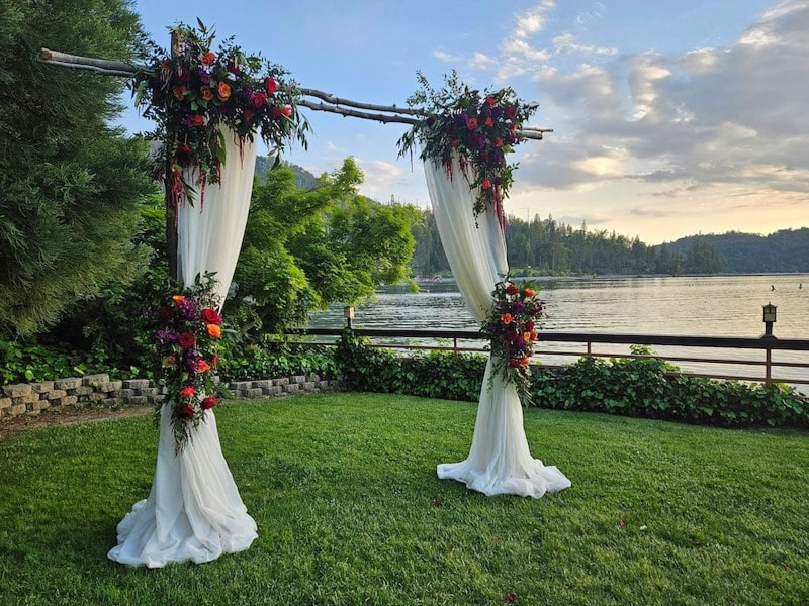 Wedding arch set against the lake at The Pines Resort in Bass Lake, California