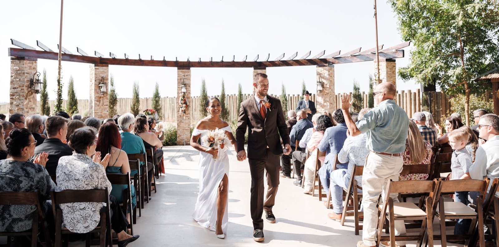Couple on the landscaped grounds at The Sunset Acres wedding venue in Fowler, California