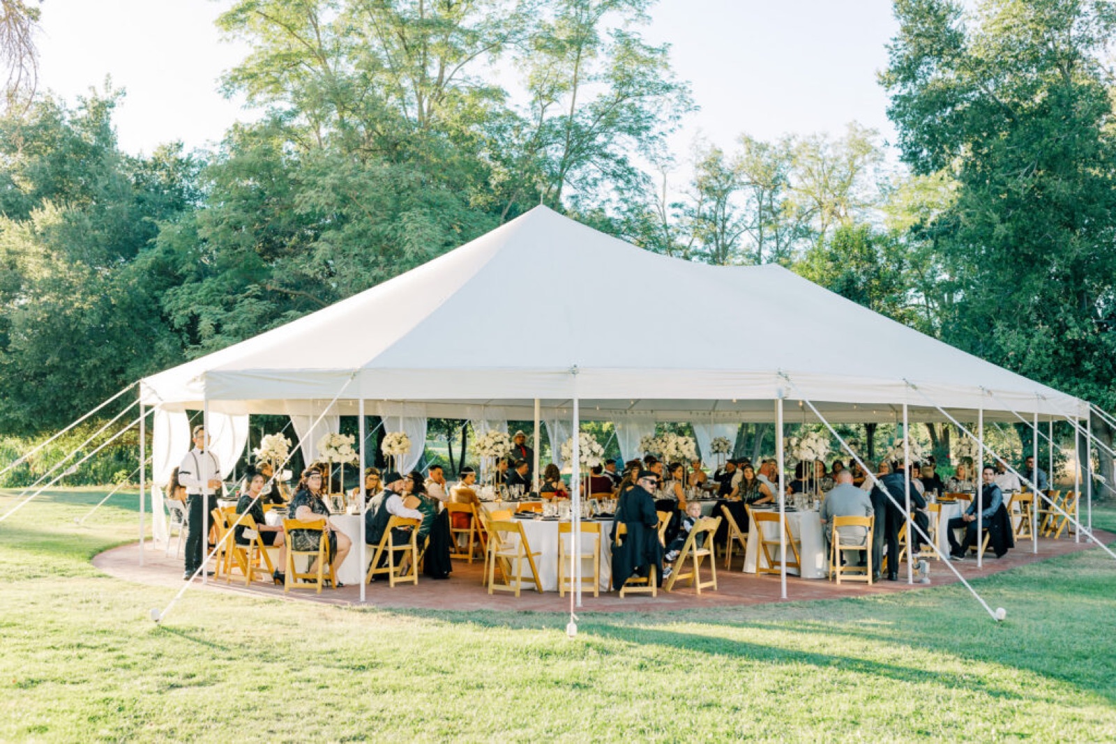 Tented reception interior set for dining at TULU Vineyards wedding venue in Galt, California