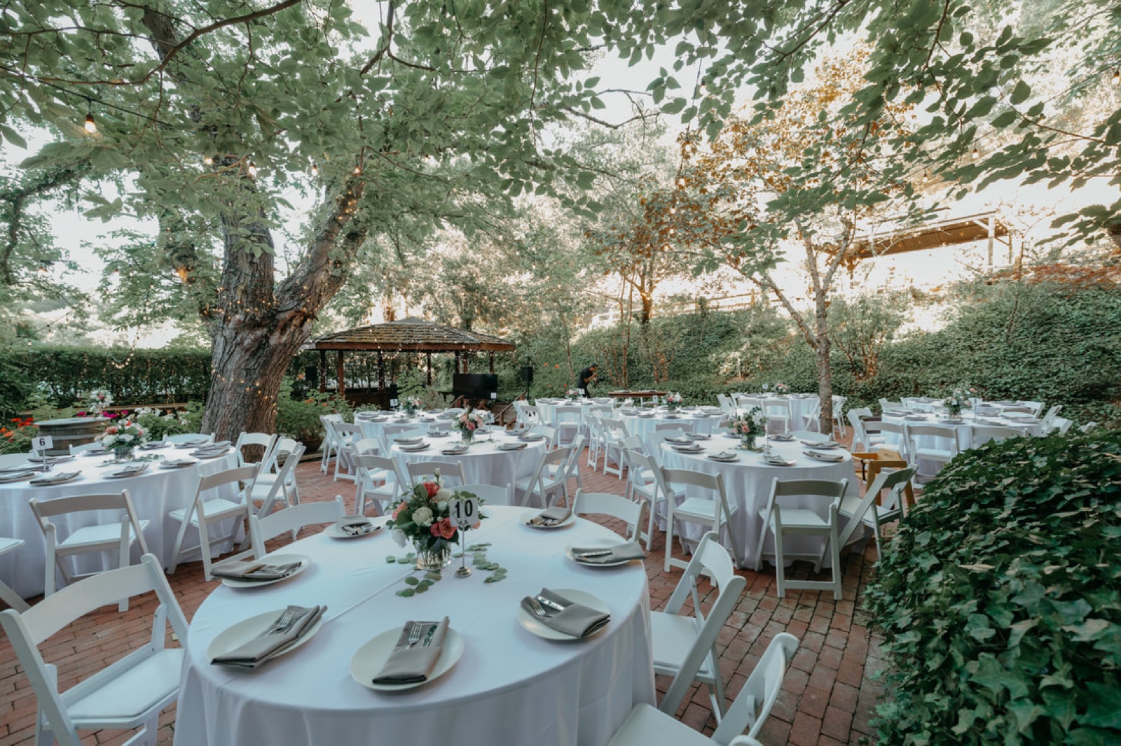 Outdoor reception terrace shaded by trees at Wildwood Acres Resort in Lafayette, California